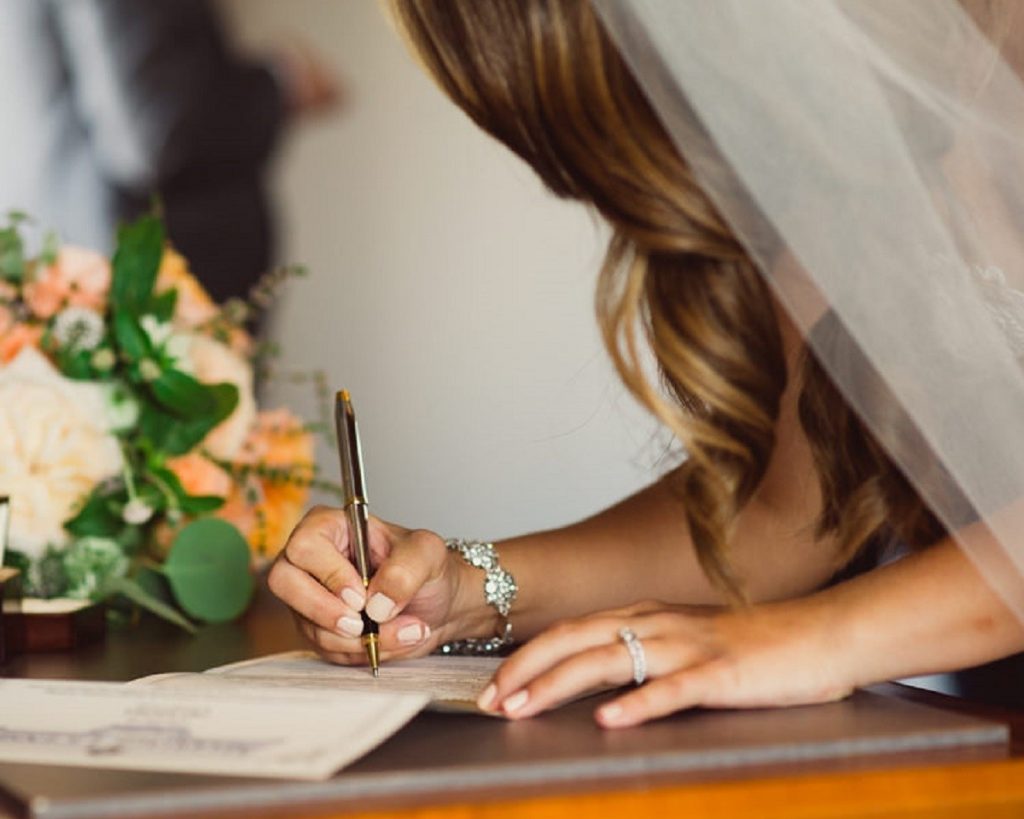 Signing a marriage license is one of the legal requirements in a wedding ceremony